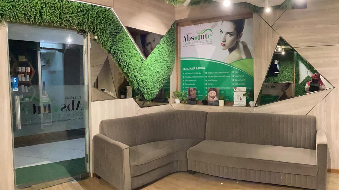Reception and waiting area at the Andheri West clinic, with a living green wall and branded signage